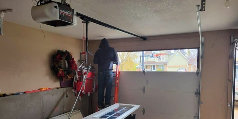 Man repairing garage door window